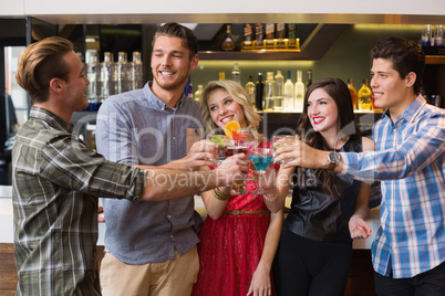 Happy friends drinking cocktails together