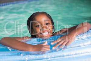 Cute little girl swimming in the pool