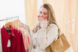 Pretty blonde woman tired during shopping