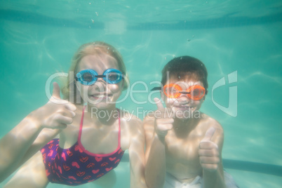 Cute kids posing underwater in pool