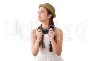 Happy brunette in hat holding phone