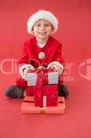 Cute little boy in santa costume with gifts