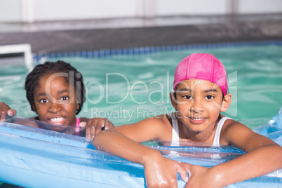 Cute little girls swimming in the pool