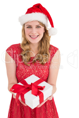 Smiling pretty woman in red dress offering present