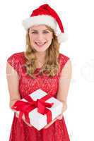 Smiling pretty woman in red dress offering present