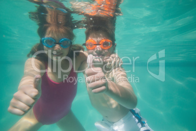 Cute kids posing underwater in pool