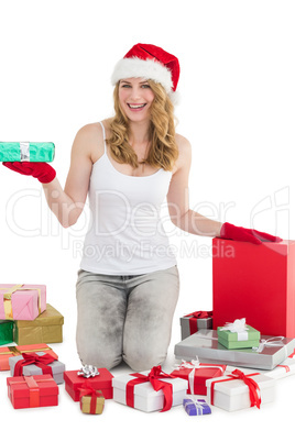 Blonde woman on her knees while holding a gift