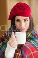 Brunette with cover holding mug