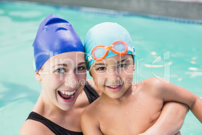 Happy mother and son in the swimming pool