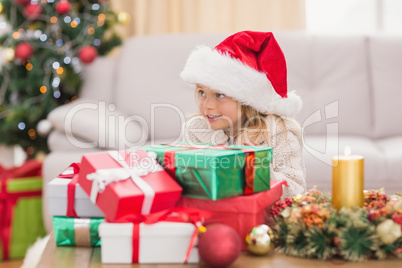 Cute little girl surrounded by christmas gifts