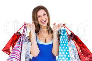 Cheerful brunette woman holding shopping bags