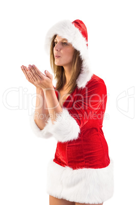 Festive brunette blowing over hands