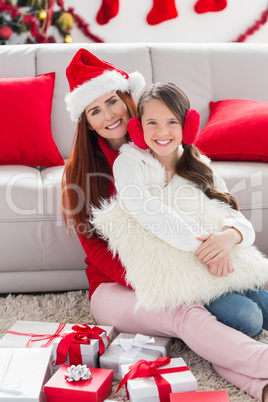 Festive mother and daughter smiling at camera