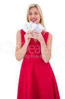 Stylish blonde in red dress holding cash