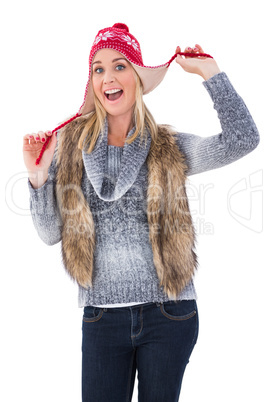 Blonde in winter clothes smiling at camera