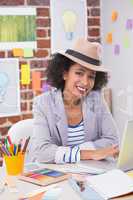 Female interior designer using laptop at desk