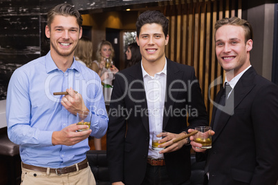 Handsome friends having a drink together