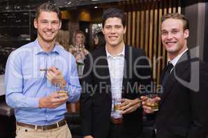 Handsome friends having a drink together