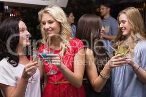 Pretty friends having a drink together