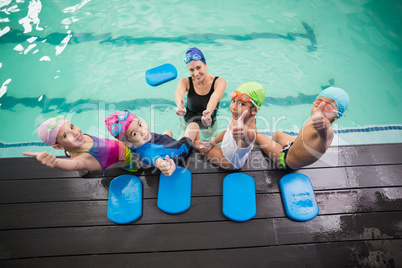 Cute swimming class and coach smiling