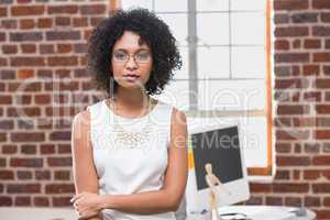 Serious young businesswoman in office