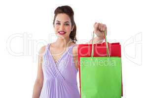 Portrait of pretty brunette showing shopping bags
