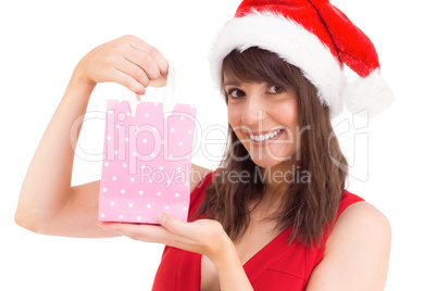 Festive brunette holding a gift bag