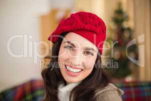 Portrait of a smiling brunette in hat at christmas