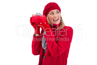 Festive blonde holding red gift