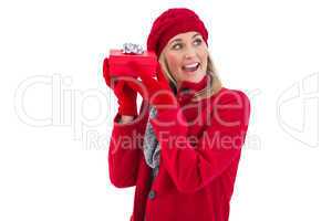 Festive blonde holding red gift