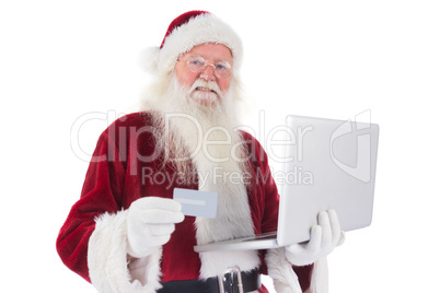 Santa pays with credit card on a laptop