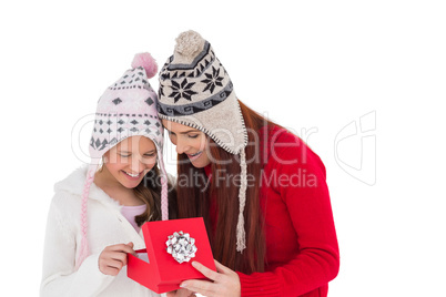 Mother and daughter opening christmas gift