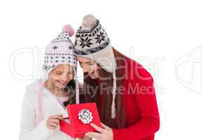 Mother and daughter opening christmas gift