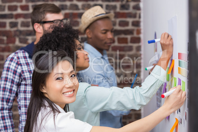 Team looking at sticky notes on wall