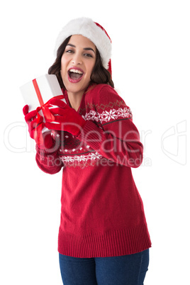 Excited brunette showing christmas present