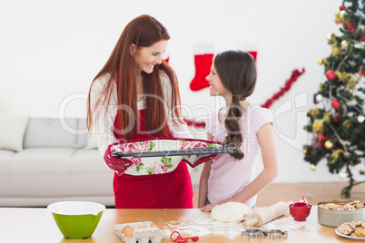 Festive mother and daughter baking together