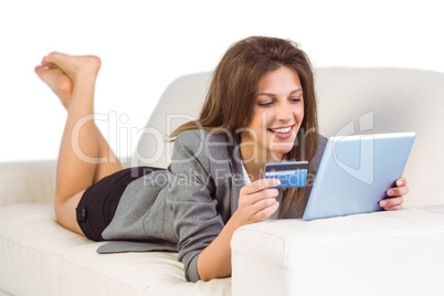 Woman doing online shopping with tablet and credit card