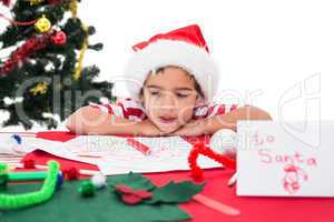 Festive little boy writing wish list