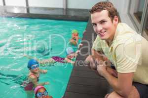 Cute swimming class listening to coach