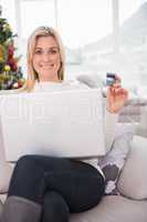 Blonde shopping online on the couch at christmas