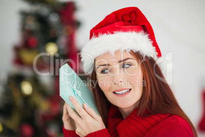 Festive redhead holding christmas gift