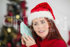 Festive redhead holding christmas gift