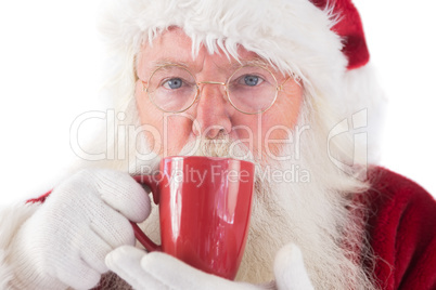 Santa drinks from a red cup