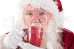 Santa drinks from a red cup