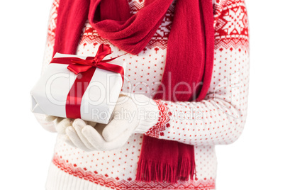 Close up of a festive brunette holding a gift