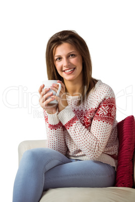 Woman sitting on the couch holding mug of coffee