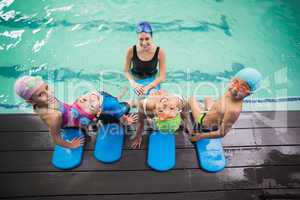 Cute swimming class and coach smiling