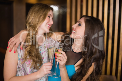 Attractive friends toasting with champagne