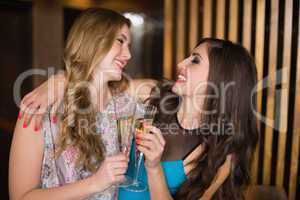 Attractive friends toasting with champagne