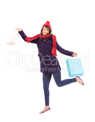 Festive brunette holding shopping bags